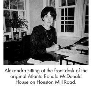 Alexandra sitting at the front desk of the original Atlanta RMHC on Houston Mill Road